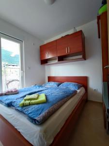 ein Bett mit zwei gelben Handtüchern darüber in der Unterkunft PORTONOVIPRC in Herceg-Novi