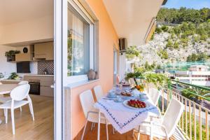 a dining room with a table and chairs on a balcony at Residence Panoramic in Maiori
