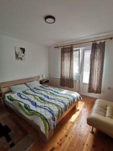 a bedroom with a bed and a window at Podinario in Soko Banja