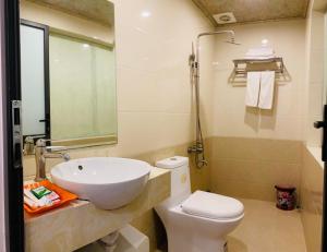 a bathroom with a sink and a toilet at Victoria hotel in Ha Long +29 photos