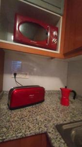 a red toaster oven on a counter in a kitchen at Casa VeraVista in Vera