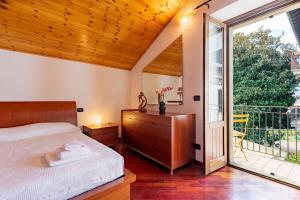 - une chambre avec un lit et une grande fenêtre dans l'établissement Gelsomino Stone House, à Stazzona