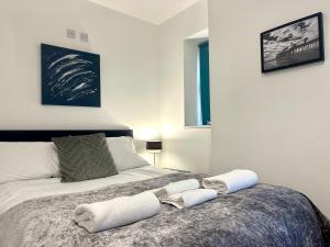 a bedroom with a bed with two towels on it at Sienna Family Holiday Apartments in Blackpool