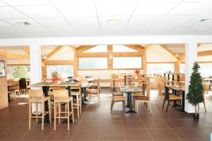 歐黑爾的住宿－Hameau 5 201a - SPA & PISCINE studio 2 pers，用餐室设有桌椅和窗户。