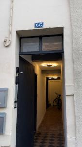 a hallway with a door and a bike in a building at Studio centre-ville RDC in Bar-le-Duc