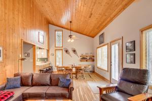 a living room with a couch and a table at Family Cabin with Private Dock on Caribou Lake! in Lutsen