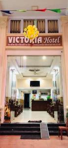 a vietnamese hotel with a sign on the front of a building at Victoria hotel in Ha Long