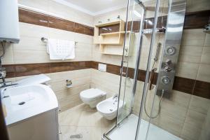 a bathroom with a shower and a toilet and a sink at DIANA MORE in Baška +18 photos