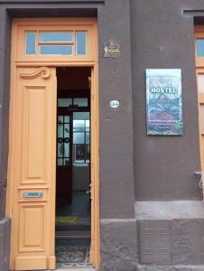 a door to a building with a sign above it at Hostel Hornocal in San Salvador de Jujuy