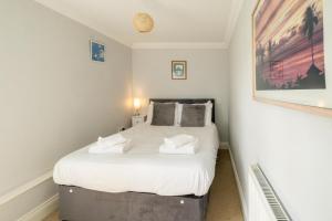 Säng eller sängar i ett rum på 1 Hazelwood, Aldeburgh