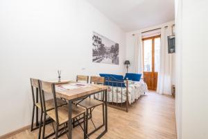 a living room with a table and a bed at Alla Marina Cagliari in Cagliari