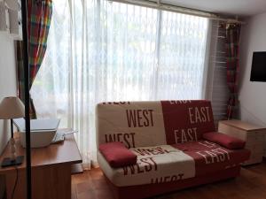 a living room with a couch and a window at Montago in Le Gosier