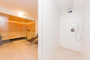 a bathroom with a shower and a glass door at Grossglockner Chalets Zell am See in Zell am See