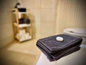a towel with a pearl on it sitting on top of a toilet at G&G Homely Apartment Horhausen Westerwald - near A3 in Horhausen