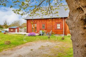 a wooden house with a table and chairs in front of it at Paisible et insolite chalet pour 4 personnes a Penmarch in Penmarcʼh