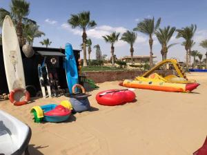 a playground with different types of play equipment on the beach at Chalet at Lasirena Mini Egypt Resort Ein Elsokhna Families Only in Ain Sokhna