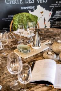 a table with wine glasses and a book on it at Körunda Golf & Conference Hotel in Ösmo +20 photos