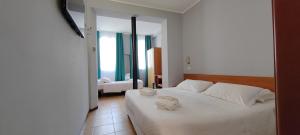 A bed or beds in a room at Hotel Nuovo Rondò