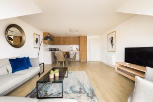 a living room with a couch and a table at Staines City Centre by Charles Hope in Staines