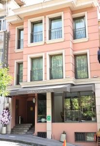 a pink building with the entrance to the savoy hotel at Saratoga Hotel Sultanahmet in Istanbul