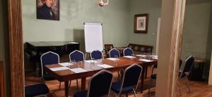 a room with a table and chairs and a piano at Chopin Boutique in Warsaw