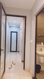 a bathroom with a toilet and a sink and a mirror at Ez mart and stay in Hai Phong