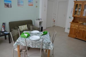 a dining room with a table and a couch at Casa Ventitré in Balestrate
