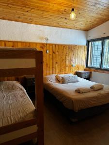 Un pat sau paturi într-o cameră la Pecoh Potrerillos - Casa de montaña