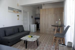 a living room with a couch and a table at Sea View in Adelianos Kampos