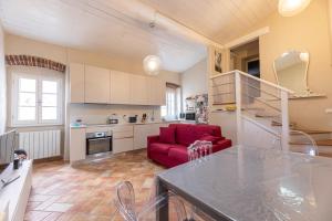 a kitchen and living room with a red couch at Il Nido di Bianca - Goelba in Portoferraio