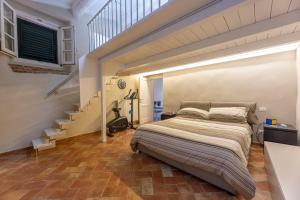 a bedroom with a bed in a room with stairs at Il Nido di Bianca - Goelba in Portoferraio