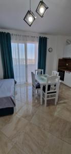 a living room with a dining room table and chairs at Oasis in Durrës