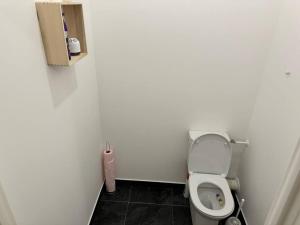 ein Bad mit einem WC in einer weißen Wand in der Unterkunft Odyssée - Appartement neuf Cergy in Cergy