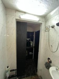 a bathroom with a shower and a sink and a mirror at Bachelor Pad Rondebosch Self Catering in Cape Town