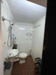 a small bathroom with a toilet and a sink at Bachelor Pad Rondebosch Self Catering in Cape Town