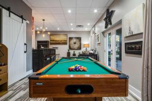 a pool table in a living room with at Rock and Roll River House in Jeffersonville