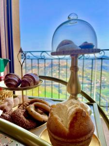 a tray of different types of pastries on a table at Dimora del Duomo in Enna