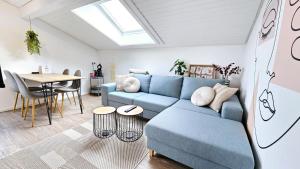 a living room with a blue couch and a table at Ferienwohnungen Krüger 'Apartment Moni' in Michelstadt