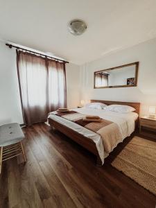 a bedroom with a large bed and a mirror at Elena Apartment- Spacious for 6, 2 Bathrooms, Free Parking in Rovinj