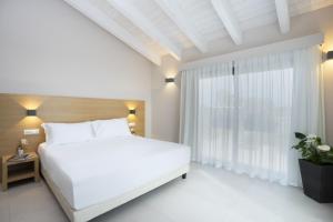 Postel nebo postele na pokoji v ubytování Ros'e Mari Green Home Hotel