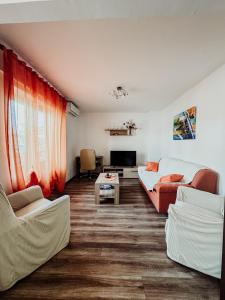 a living room with a couch and a table at Elena Apartment- Spacious for 6, 2 Bathrooms, Free Parking in Rovinj