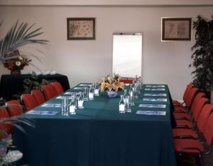 a long table in a room with red chairs at Aparthotel VIP Executive Suites do Marquês in Lisbon