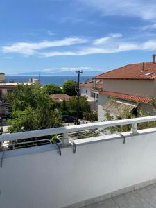 a white balcony with a view of the ocean at Sun & Sea in Nea Irakleia