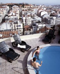a man and a woman are in a swimming pool at Aparthotel VIP Executive Suites do Marquês in Lisbon