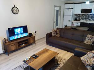 a living room with a couch and a tv at Eryaman, Wide Luxury Rezidance in Etimesut