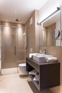 a bathroom with a sink and a shower at Spa Apartments - Zell am See in Zell am See