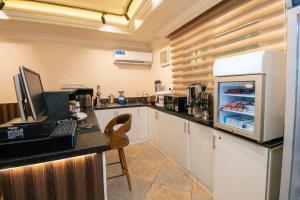 a kitchen with a counter with a refrigerator at Layali Al Tamayoz 2 in Jeddah