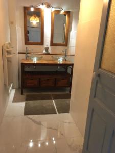 a bathroom with two sinks and two mirrors at appartement 3 chambres biarritz aguilera in Biarritz