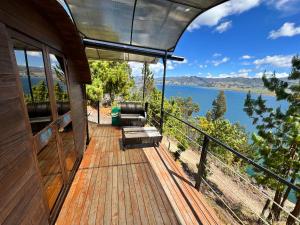 a deck of a house with a view of a lake at Custodiablue in Aquitania