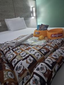 a bed with a blanket with panda bears on it at ARAGUAIA HOTEL in Barra do Garças